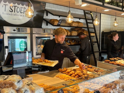 Franchisenemer van ’t Stoepje helpt klanten bij de marktstand